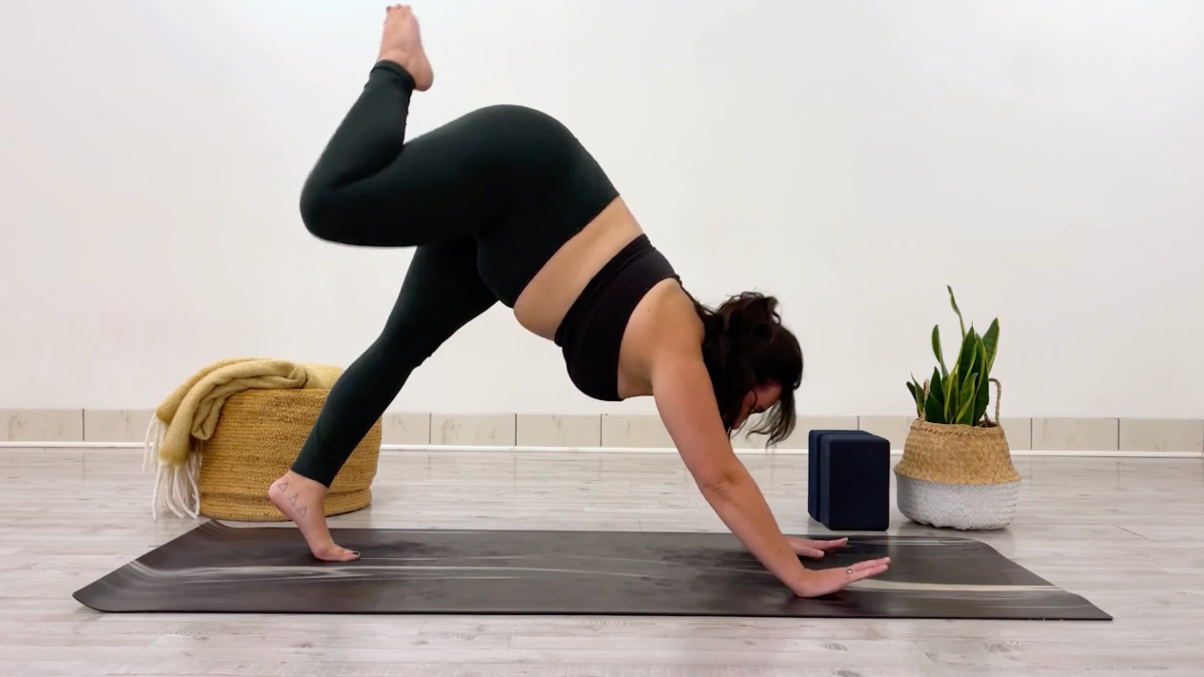 Yoga teacher Taylor Lorenz in Three-Legged Dog